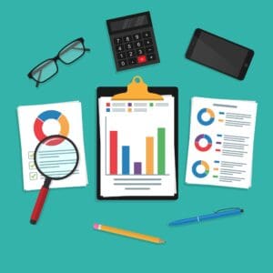 Office desk with charts, calculator, glasses, magnifying glass, and smartphone for retirement planning and financial security.